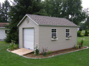 Atlantic Storage Shed. Vinyl siding mini barn with roll top door and windows