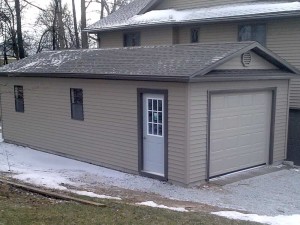 Mini Garage built to match the existing house by Martin's Mini Barns